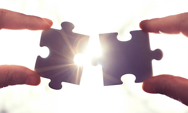 Puzzle pieces and human hands